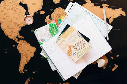 map on the background with papers and visa on top